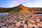 A view of the Giant's Causeway's rock formations at sunset.