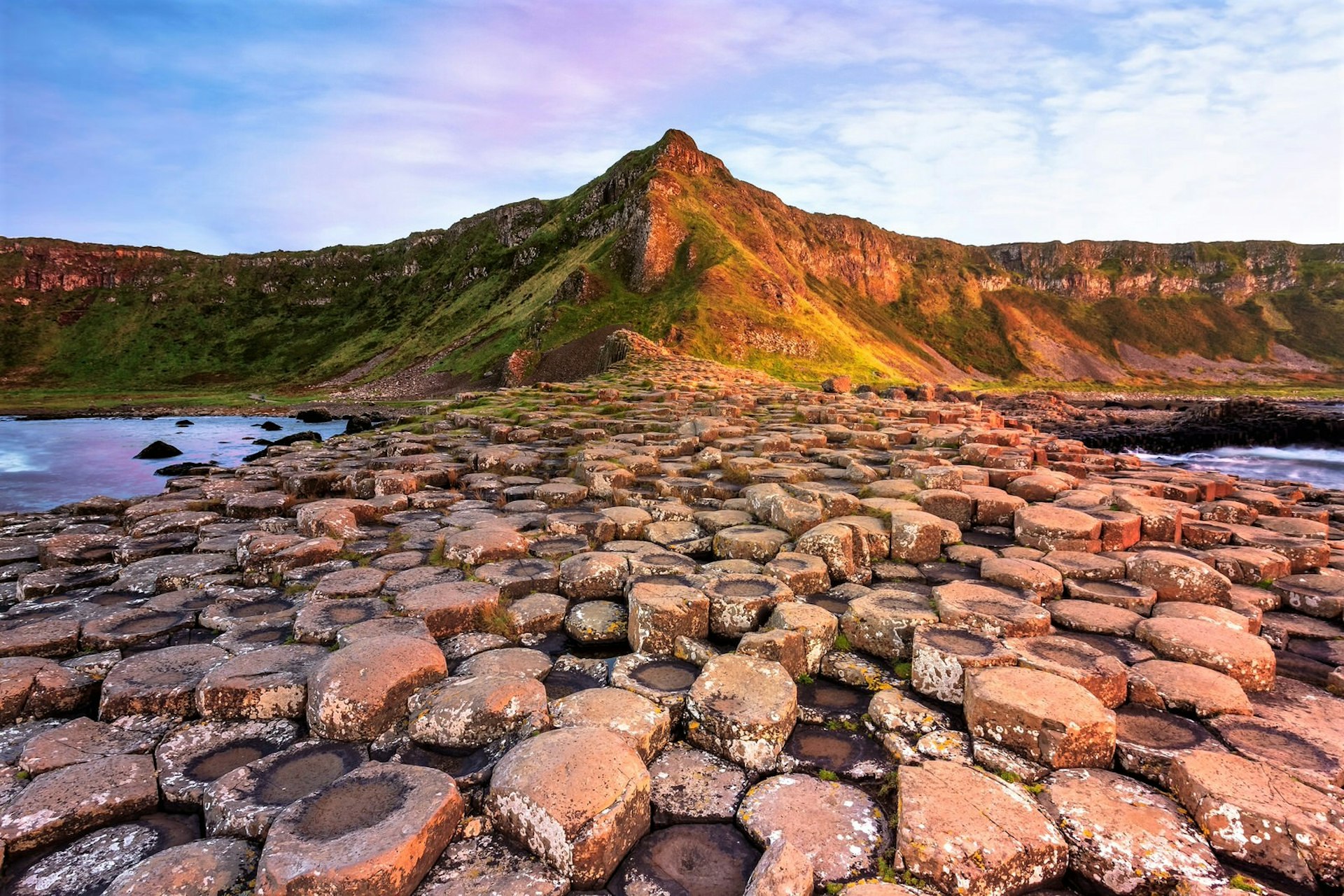 A view of the Giant's Causeway's rock formations at sunset in Antrim, Ireland.