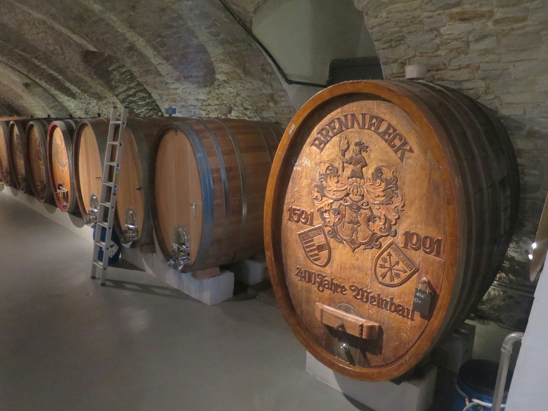 Handcarved Franconian oak barrels at Weingut Brennfleck in Sulzfeld, Germany. The huge barrels are housed in a stone basement 