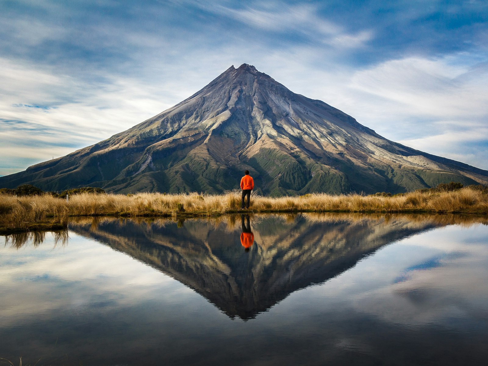 A mountaineer looking at the Taranaki volcano in the north island of New Zealand