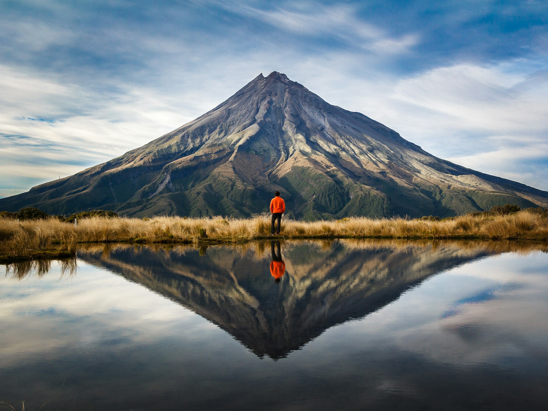 A mountaineer looking at the Taranaki volcano in the north island of New Zealand
