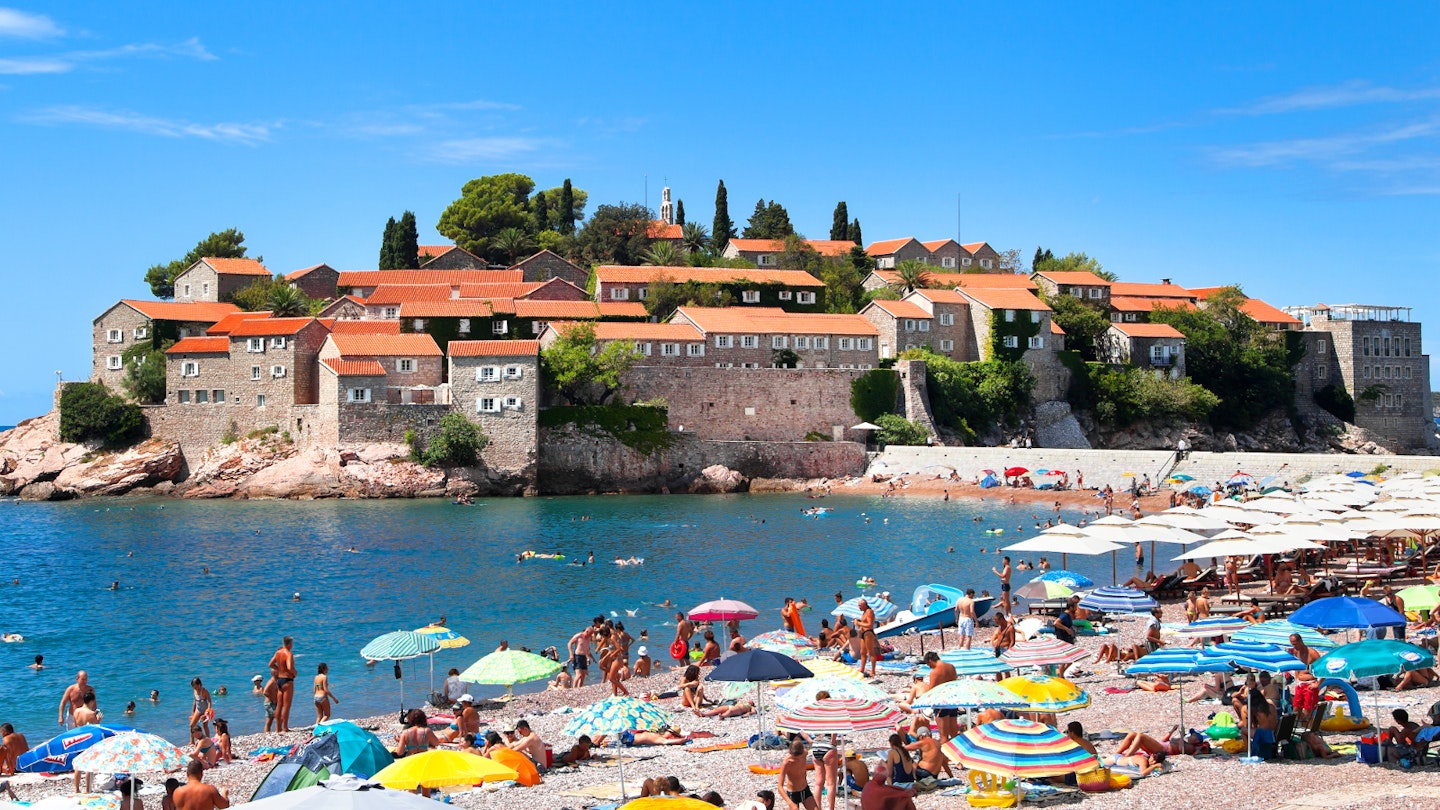 Gorgeous views of Sveti Stefan from the pinkish sands at its southern end © photosmatic / Shutterstock