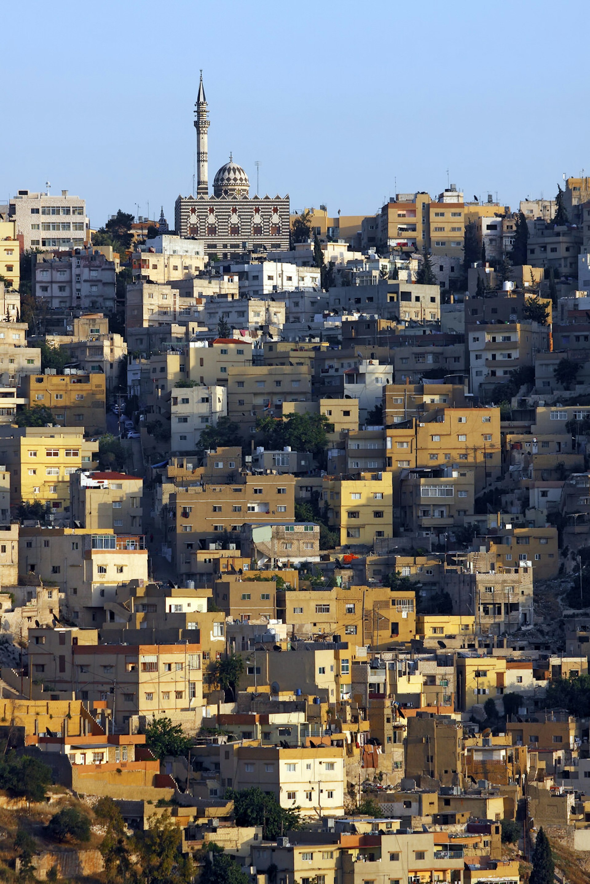 Mosque and houses in Amman, Jordan's capital, at sunset