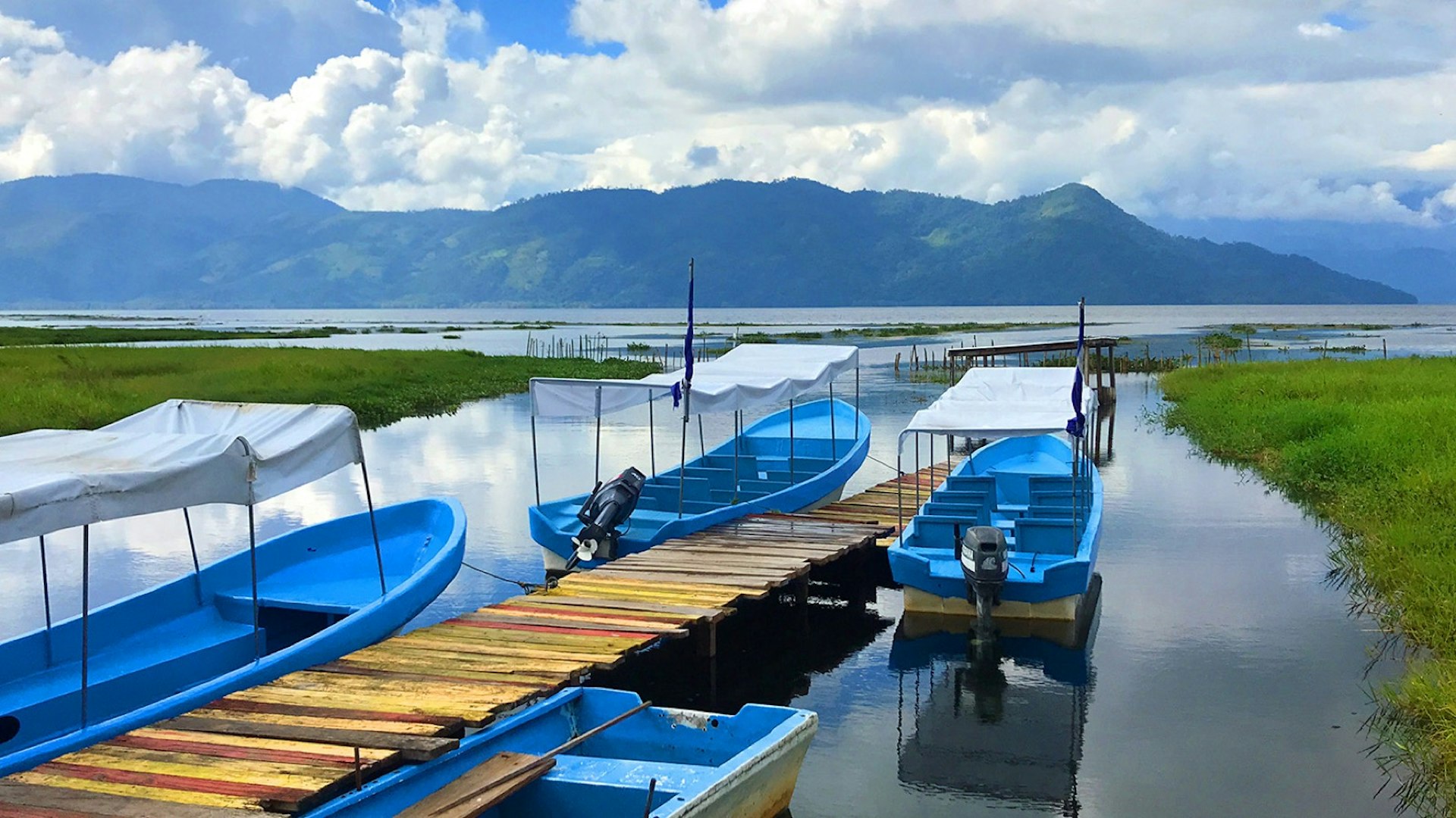 A collection of boats sit docked in Lake Yojoa in Honduras © Erik R. Trinidad / Lonely Planet 