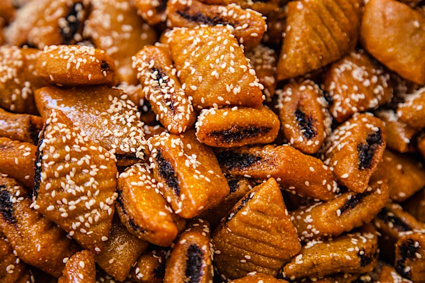 Close-up of makroudh, traditional Tunisian sweets, mainly made of durum wheat semolina, olive oil, dates, then deep fried in oil and soaked in honey syrup.