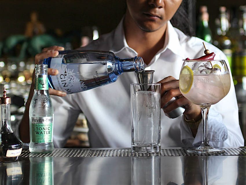 Bartender preparing a cocktail at Drinksmith bar in Chiang Mai