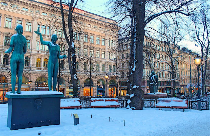 Statues of women in a snow-covered Esplanadi Park, which runs through the centre of Helsinki