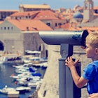 Features - family looking through binoculars at the city