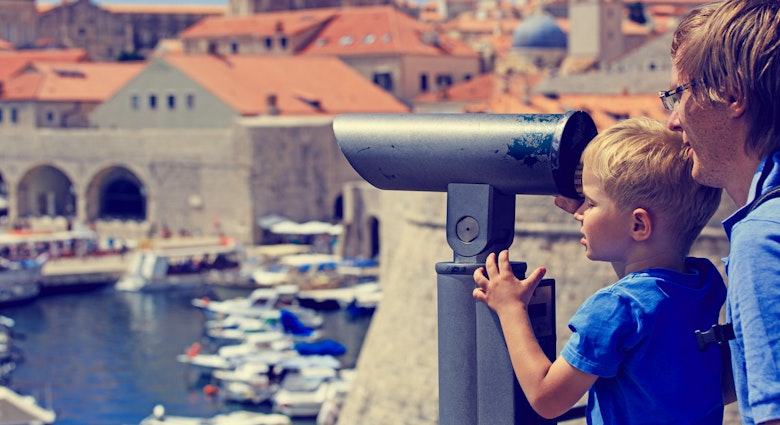 Features - family looking through binoculars at the city