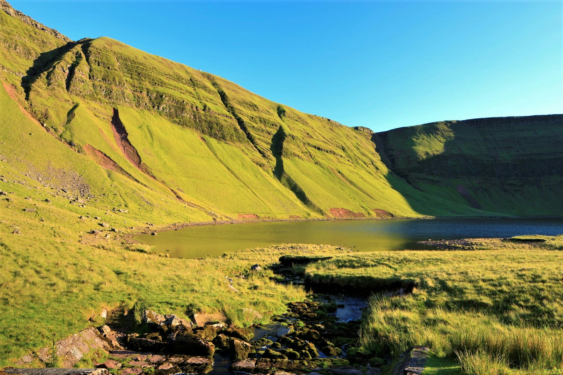 The glacial lake of Llyn y Fan Fach in the sunshine © Loop Images / UIG via Getty Images