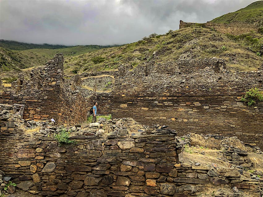 Features - Iskanwaya2_Bolivia_edited-ff3c0c2996df A man stands among ruined stone walls on a cloudy day in Iskanwaya, Bolivia