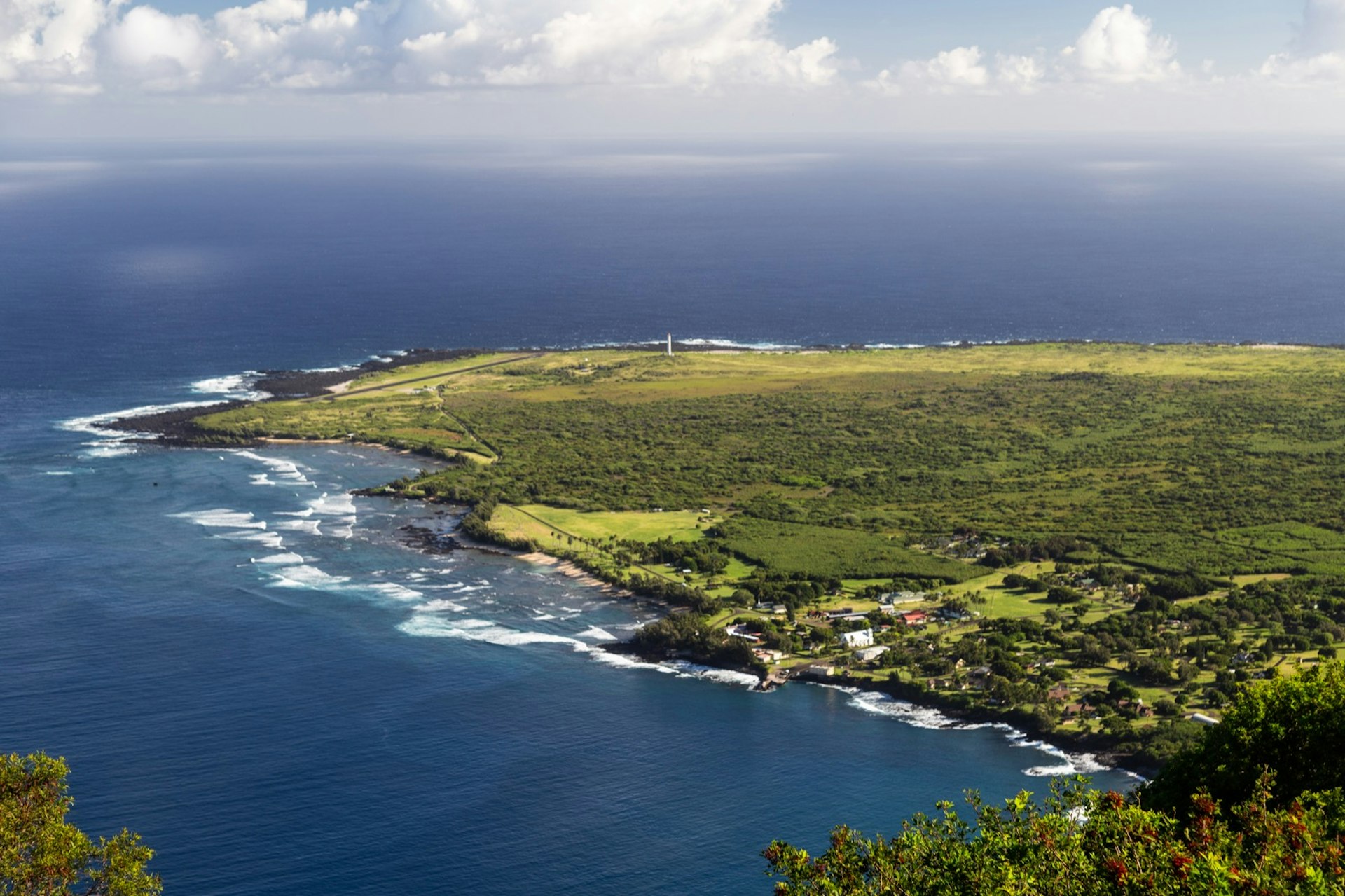 Looking down at the peninsula of Kalaupapa from the top of one of the nearby cliffs, with a tiny village visible on the near shore