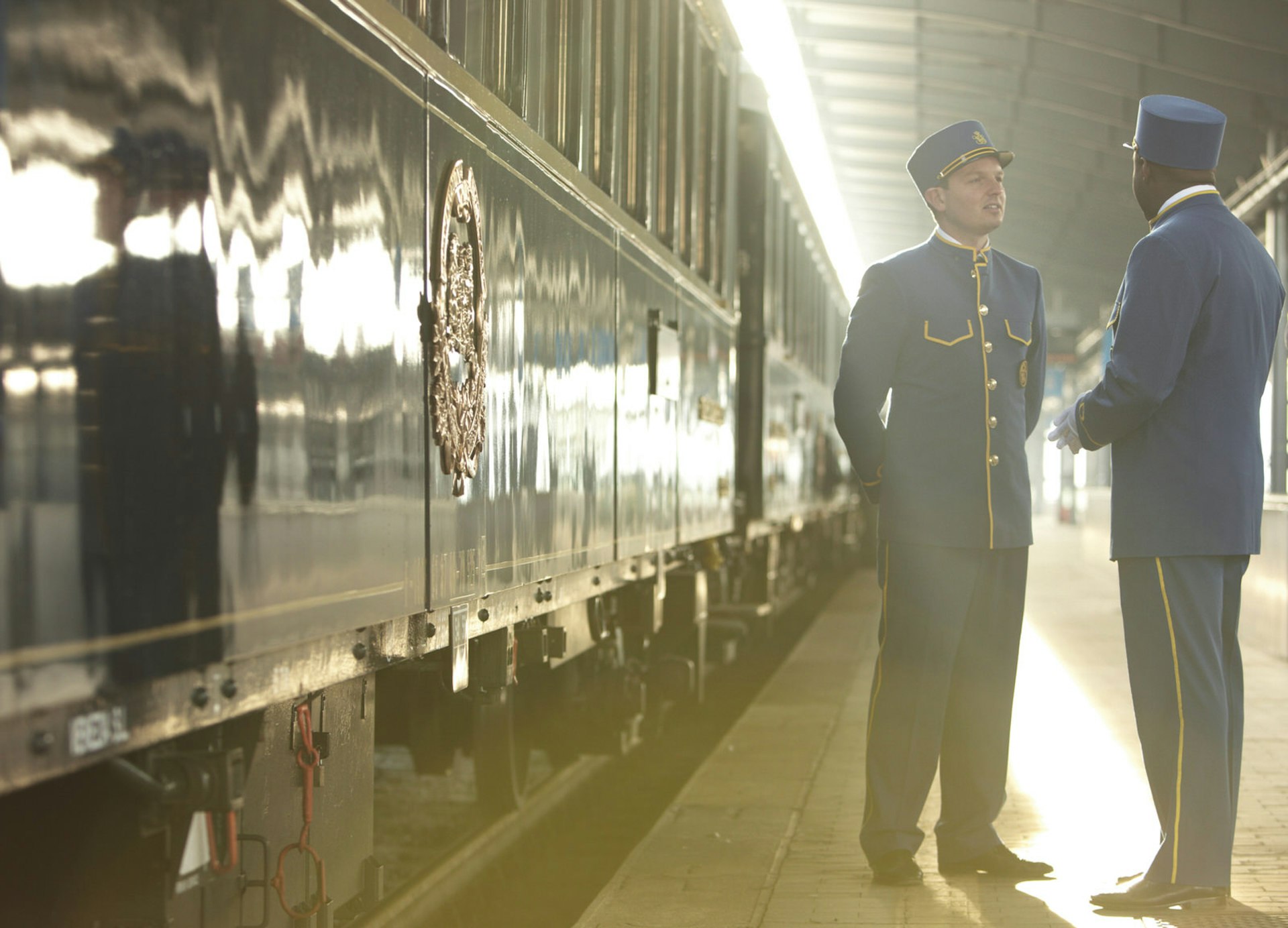 Station attendants beside Orient Express at station