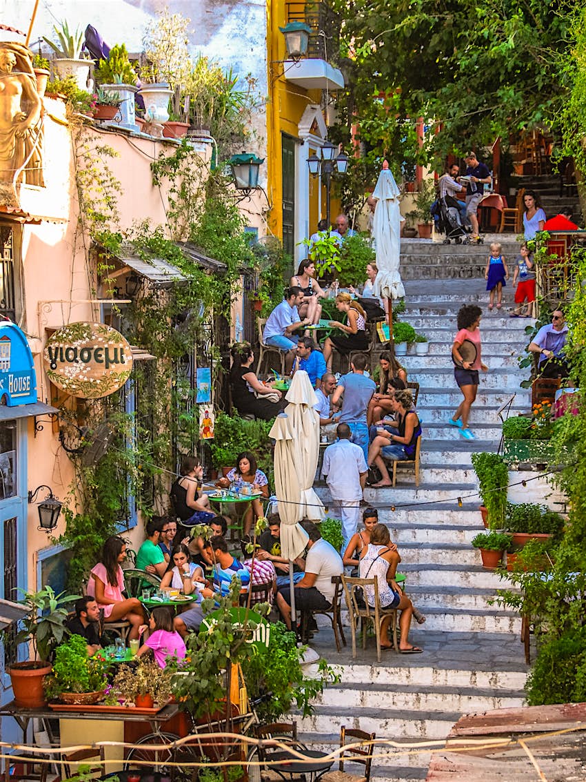 People dining outside on the stairs in the Plaka district of Athens 