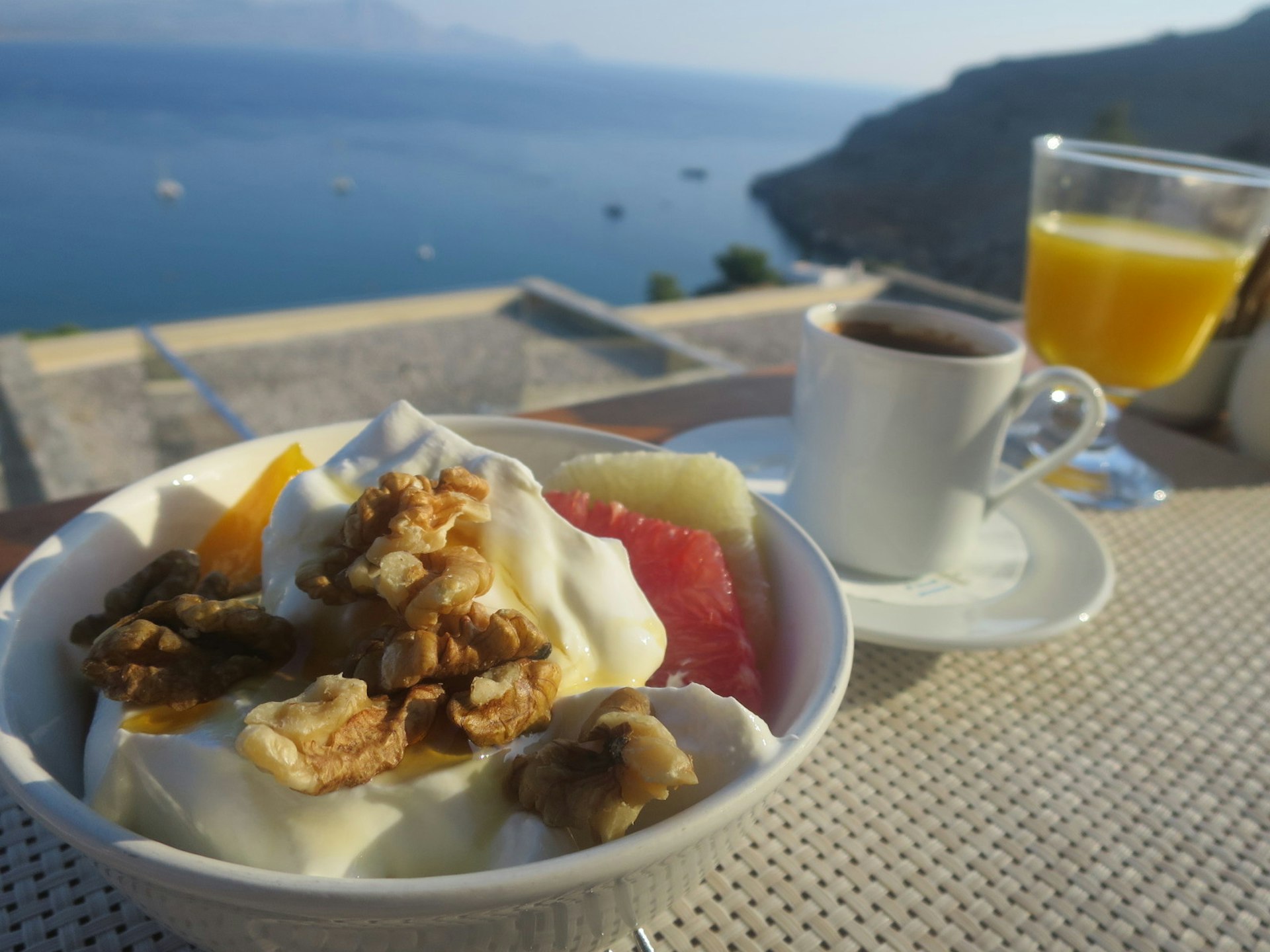 Greek yoghurt, walnuts, honey and fruit served for breakfast on Rhodes island