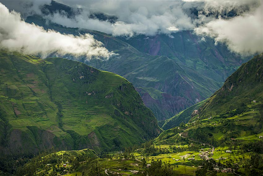 Features - Clouds over valley, Sorata, Cordillera Real, Bolivia, South America An aerial image of a green valley with steep mountains on either side near Sorata, Bolivia