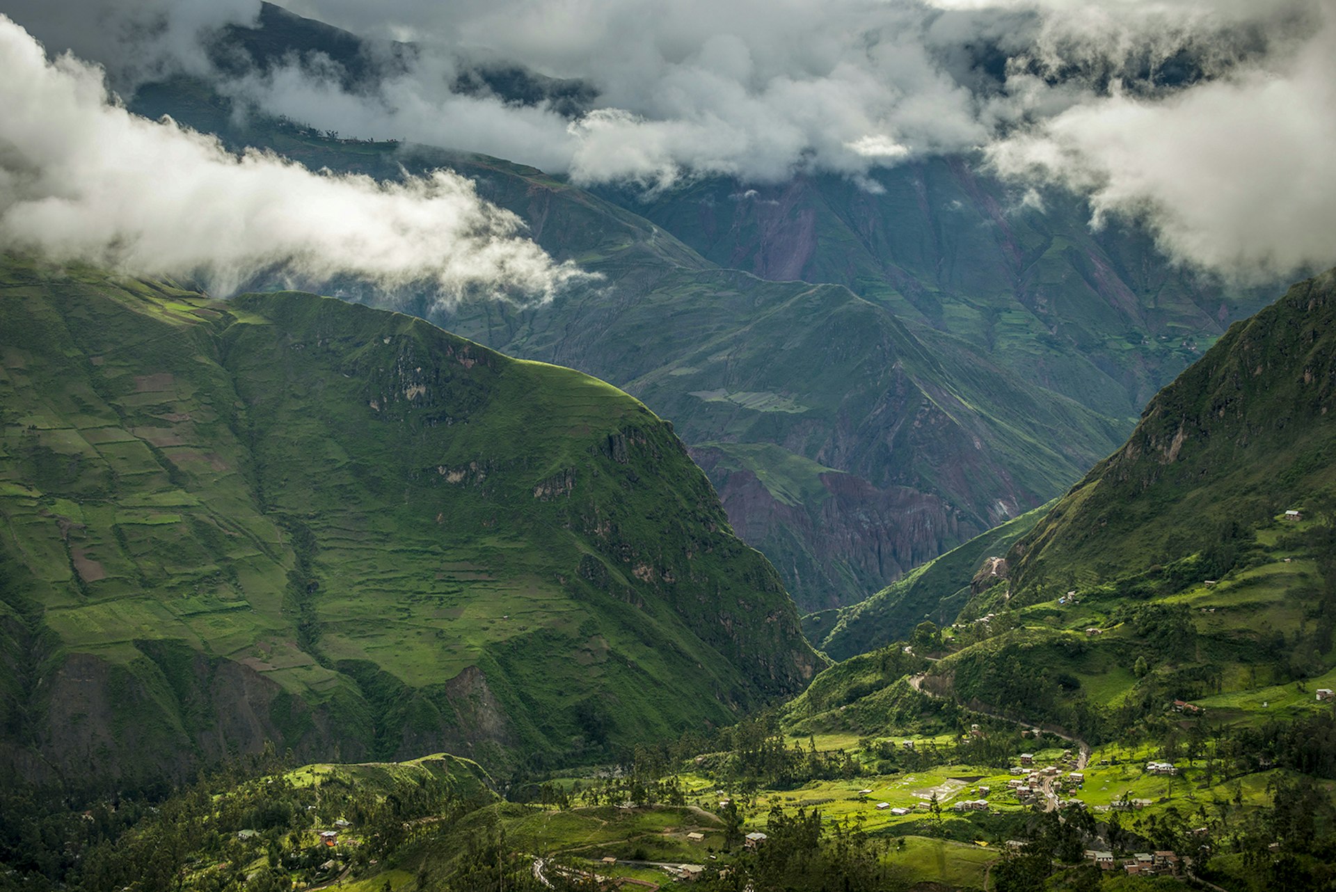 An aerial image of a green valley with steep mountains on either side near Sorata, Bolivia