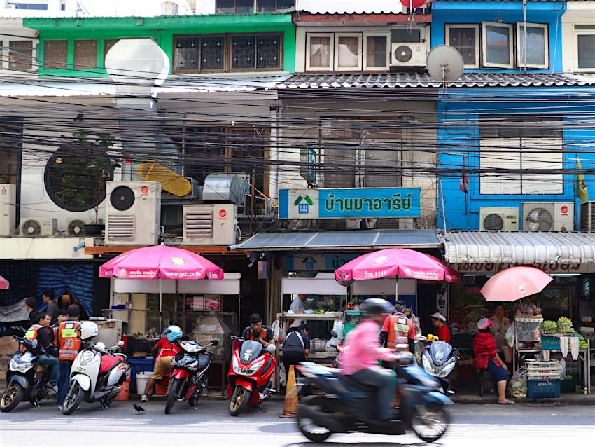 Phahon Yothin 7 in Ari district, lined with street food stalls, seamstresses and cobblers