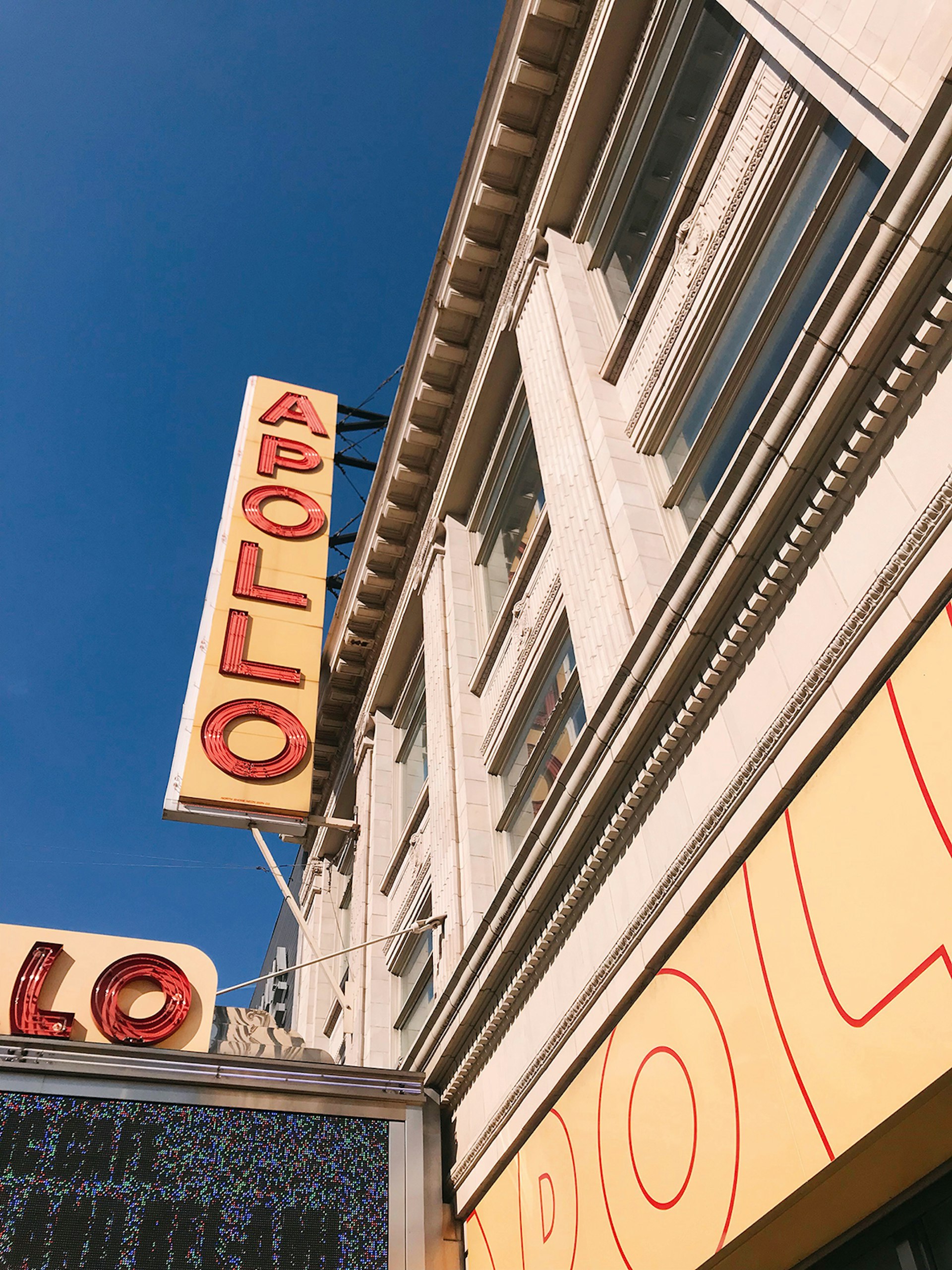 Upward-looking shot of the neon sign of the Apollo theater in Harlem