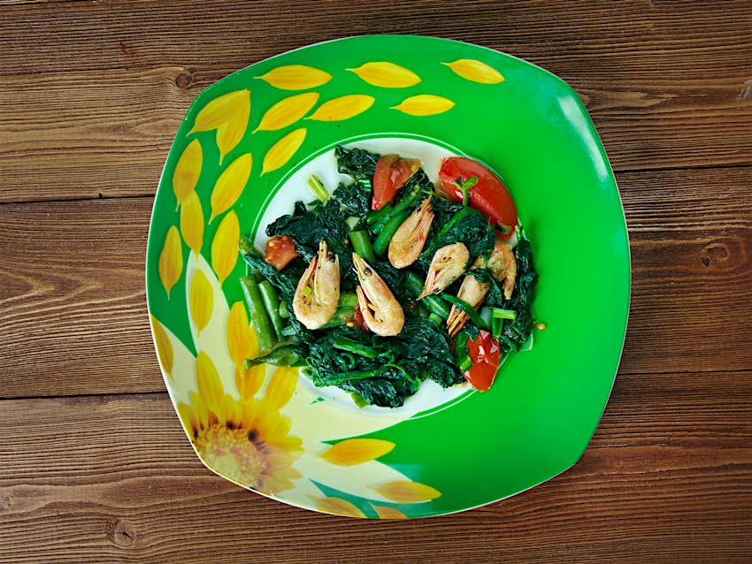 Features - callaloo-Cayman-Islands-2eae84cbdd84 Jamaican callaloo (leafy green) served with shrimp makes for a healthy and colorful meal © Fanfo / Shutterstock