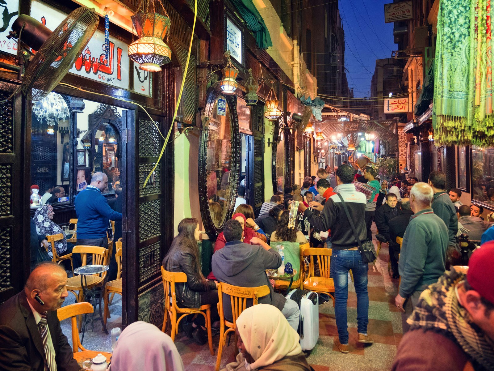Tourists and locals in the alleyway outside Fishawy Cafe, the oldest coffeehouse in Egypt