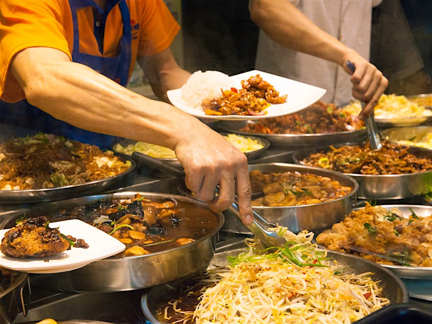 A Singaporean food stall heaving with cheap, tasty dishes