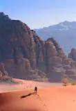 A hiker on a ridge in the desert in Wadi Rum, Jordan