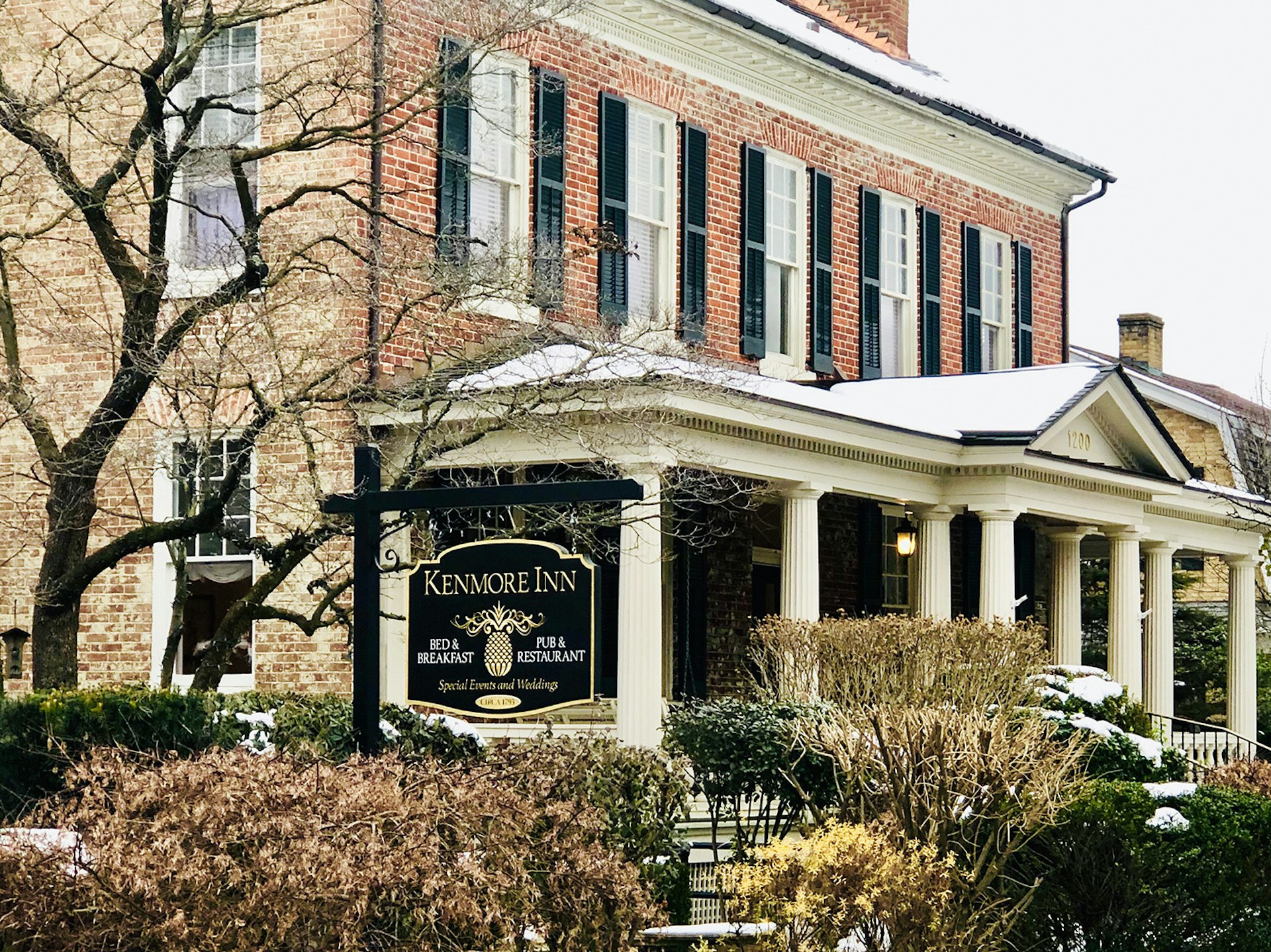 Late 18th-century Federal style home-turned-inn, with a light dusting of snow on the portico