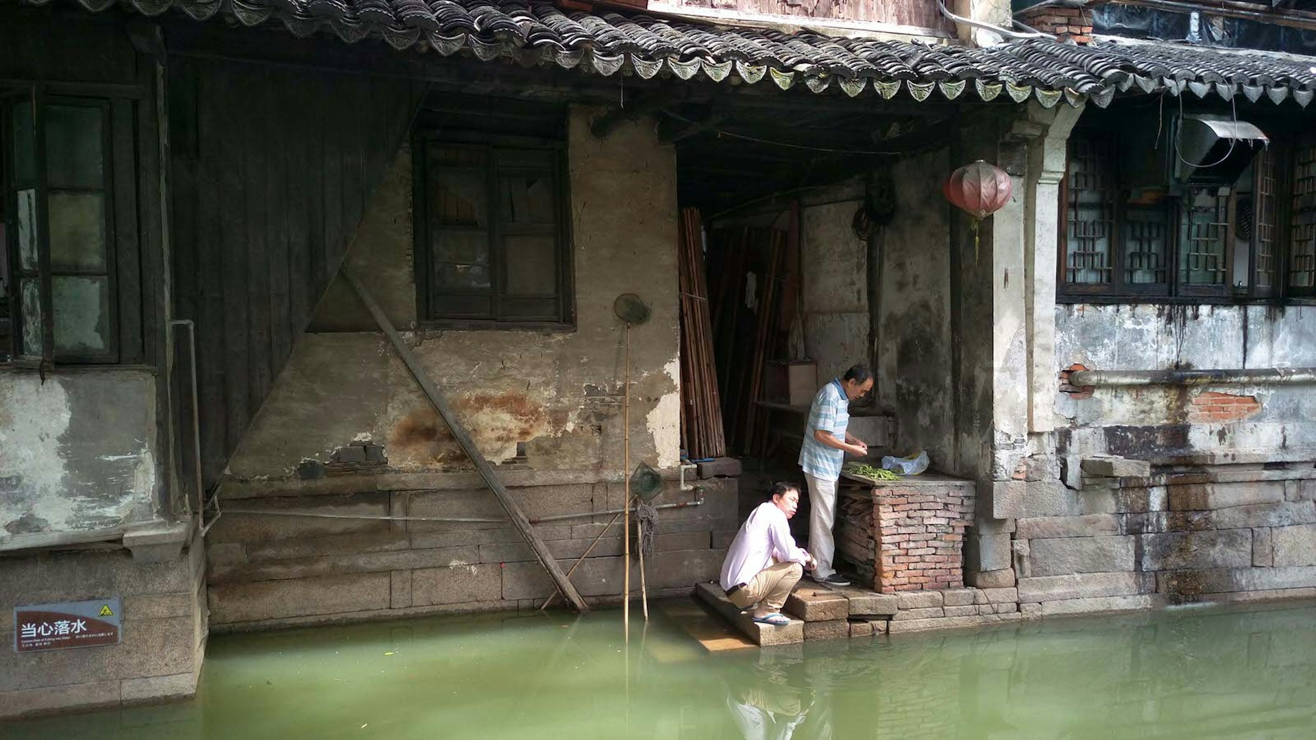 Locals preparing food by the water