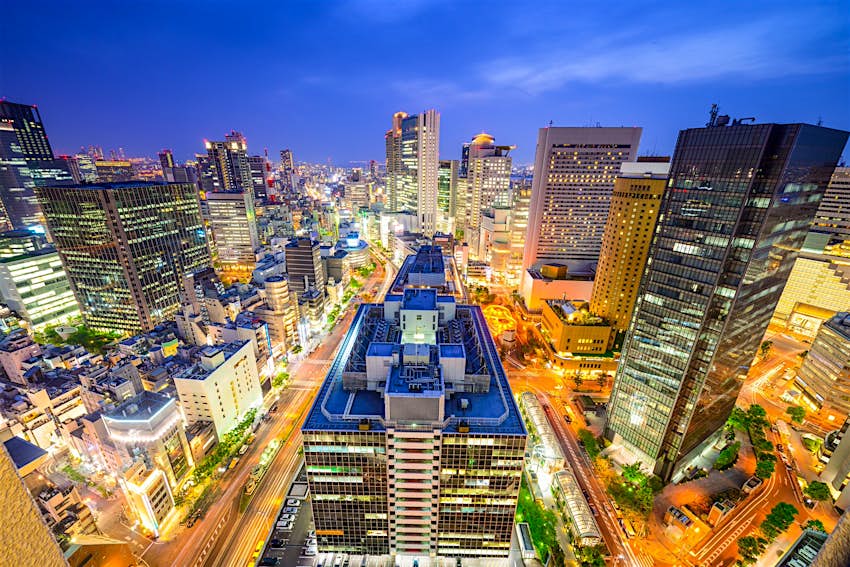 Seen from above Osaka's Umeda District, the city is a maze of bright lights beneath the dark sky 
