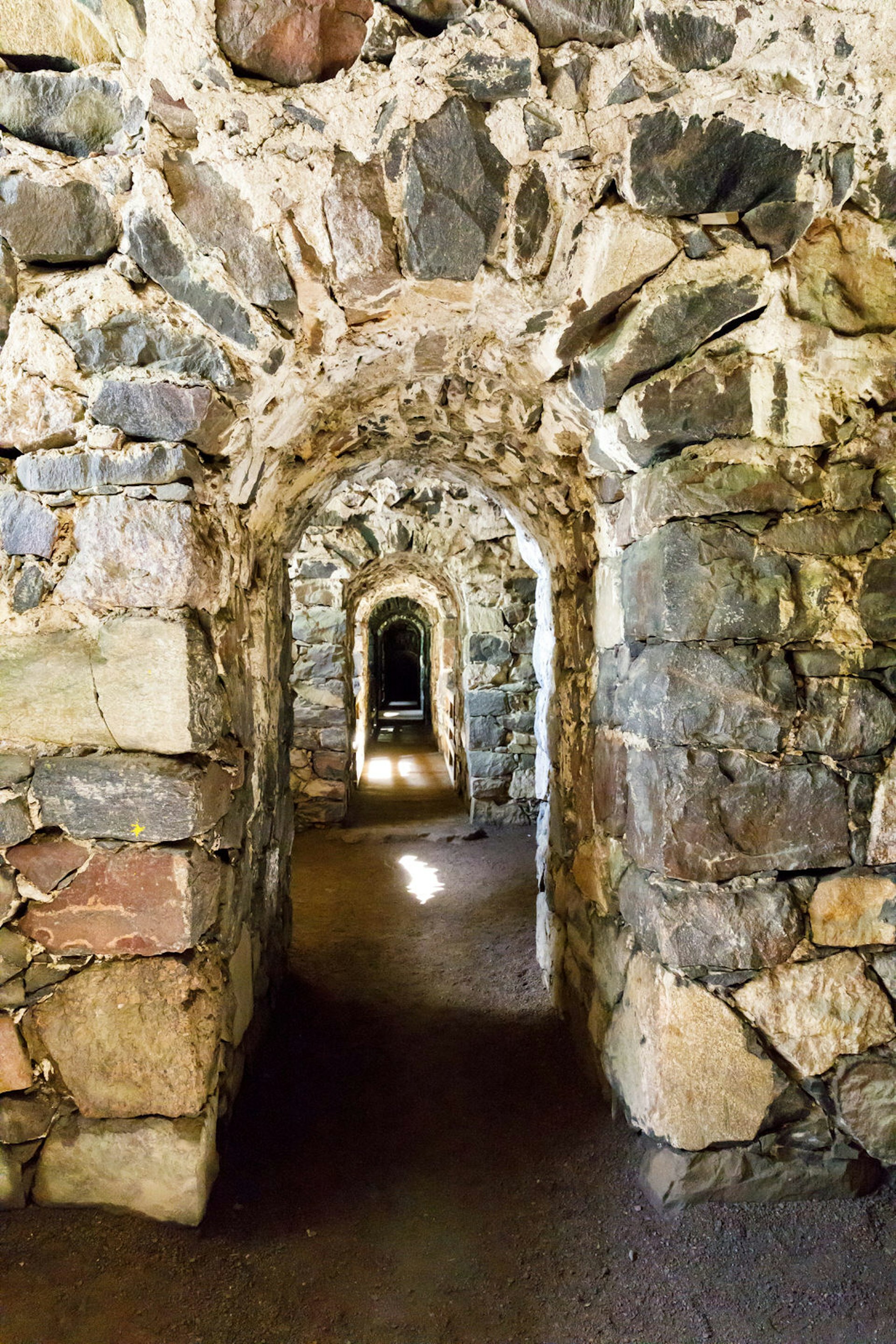 View through a series of stone archways inside Suomenlinna's fortress walls, Helsinki