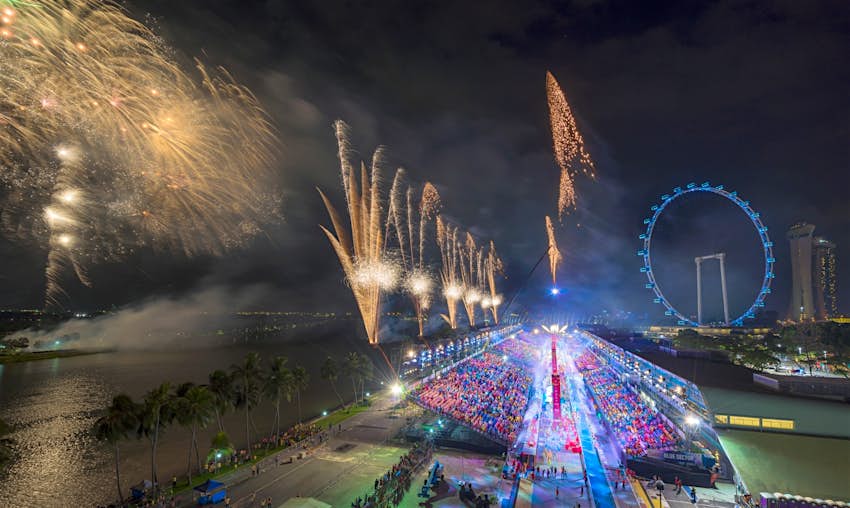 A wide angle shot of the Chingay parade, with fireworks. 