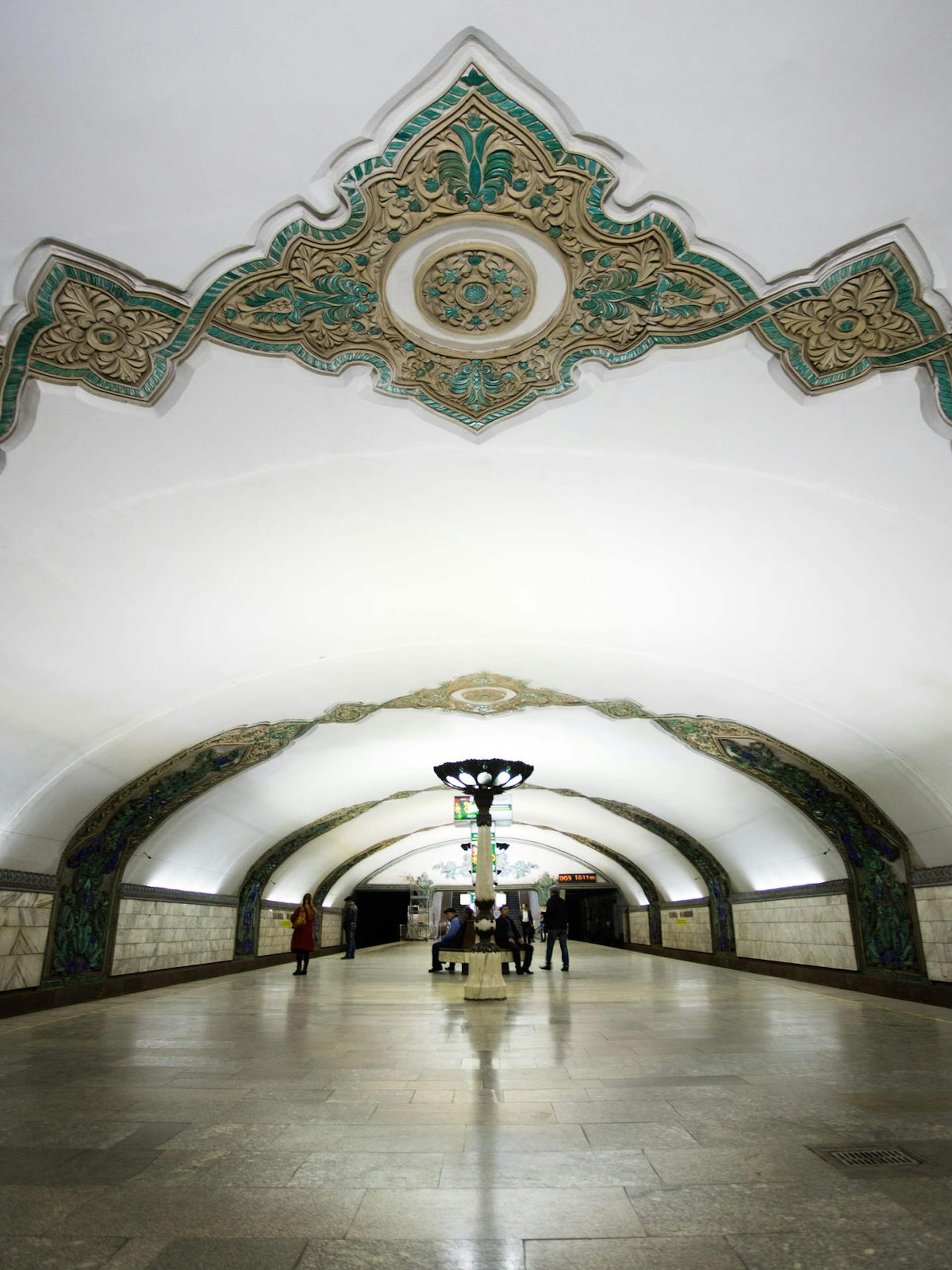 Khamid Olimjon station's mainly white domed ceiling decorated with geometric flourishes.