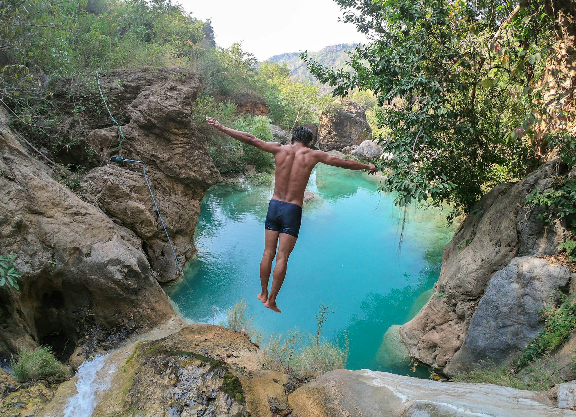 A man jumps from the falls at Dee Doke
