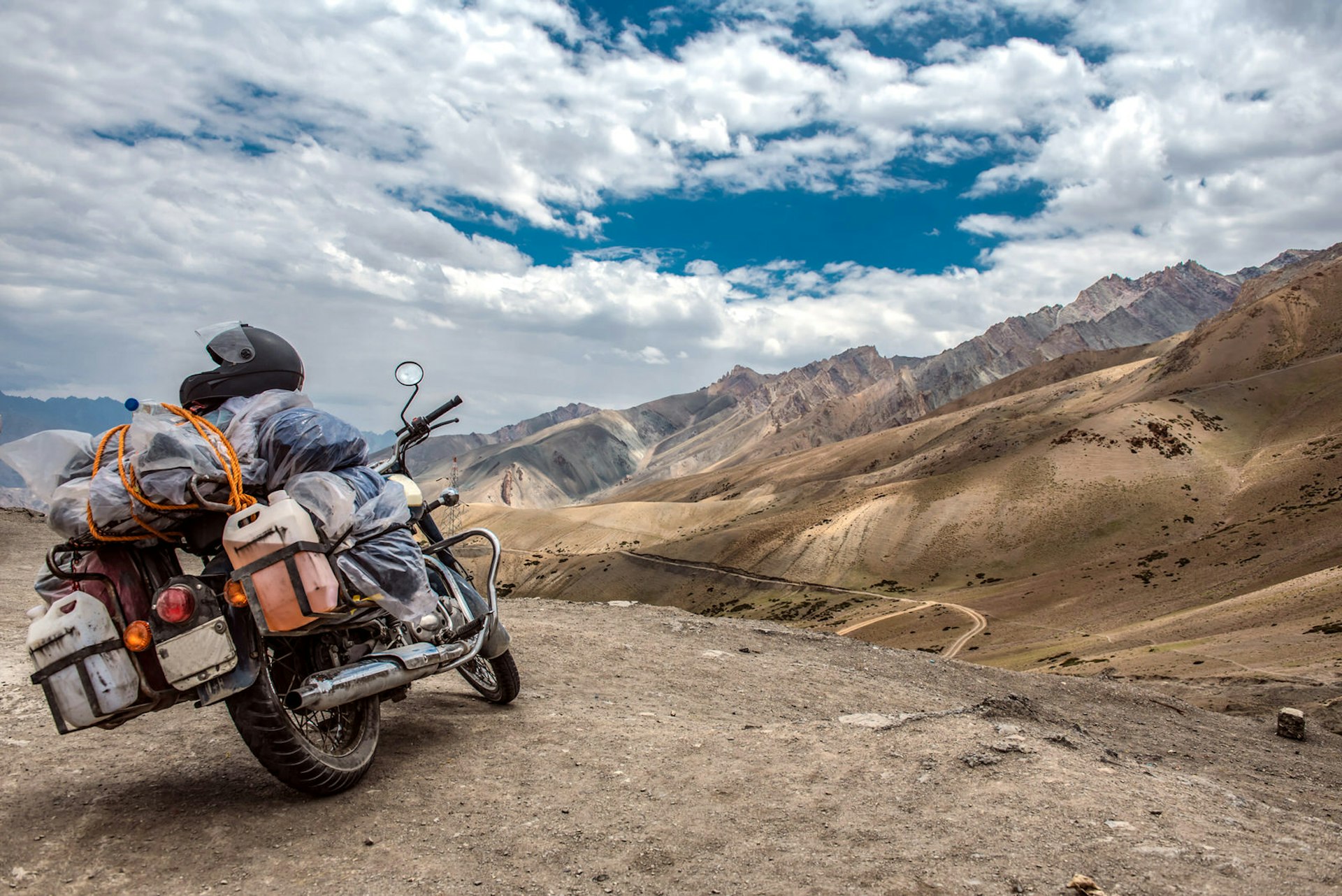 Motorcycle parked in an arid desert landscape in Spiti in Himachal Pradesh