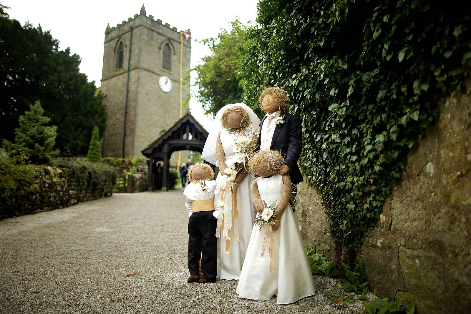 Scaregrow family dressed in wedding outfits next to a church