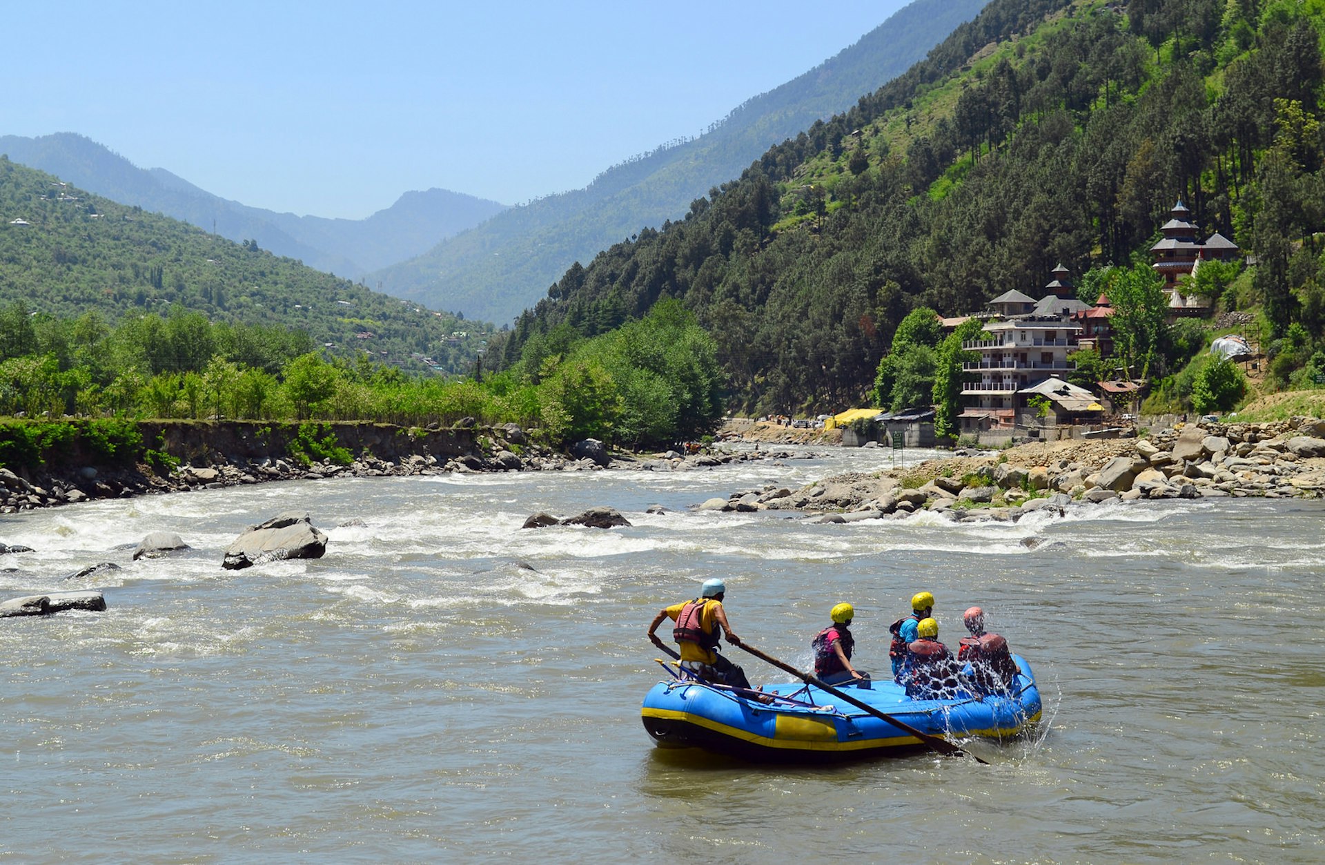 Whitewater rafters glide towards rapids in Himachal Pradesh