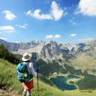 Features - Female tourist watching Trnovacko lake in Maglic mountain