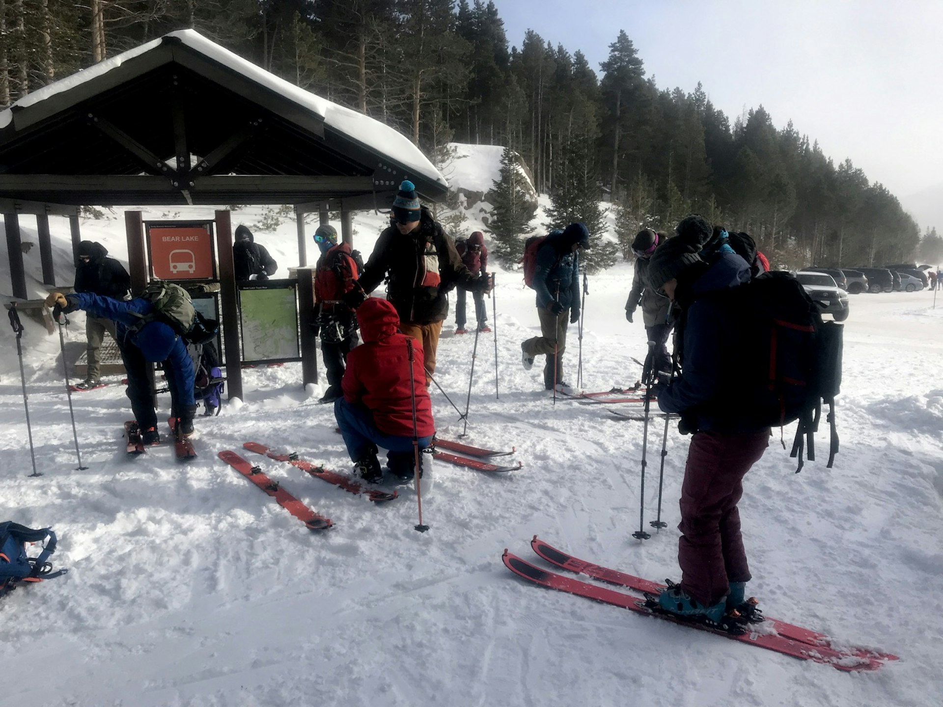 Skiiers get geared up for a backcountry excursion at a trailhead in the park