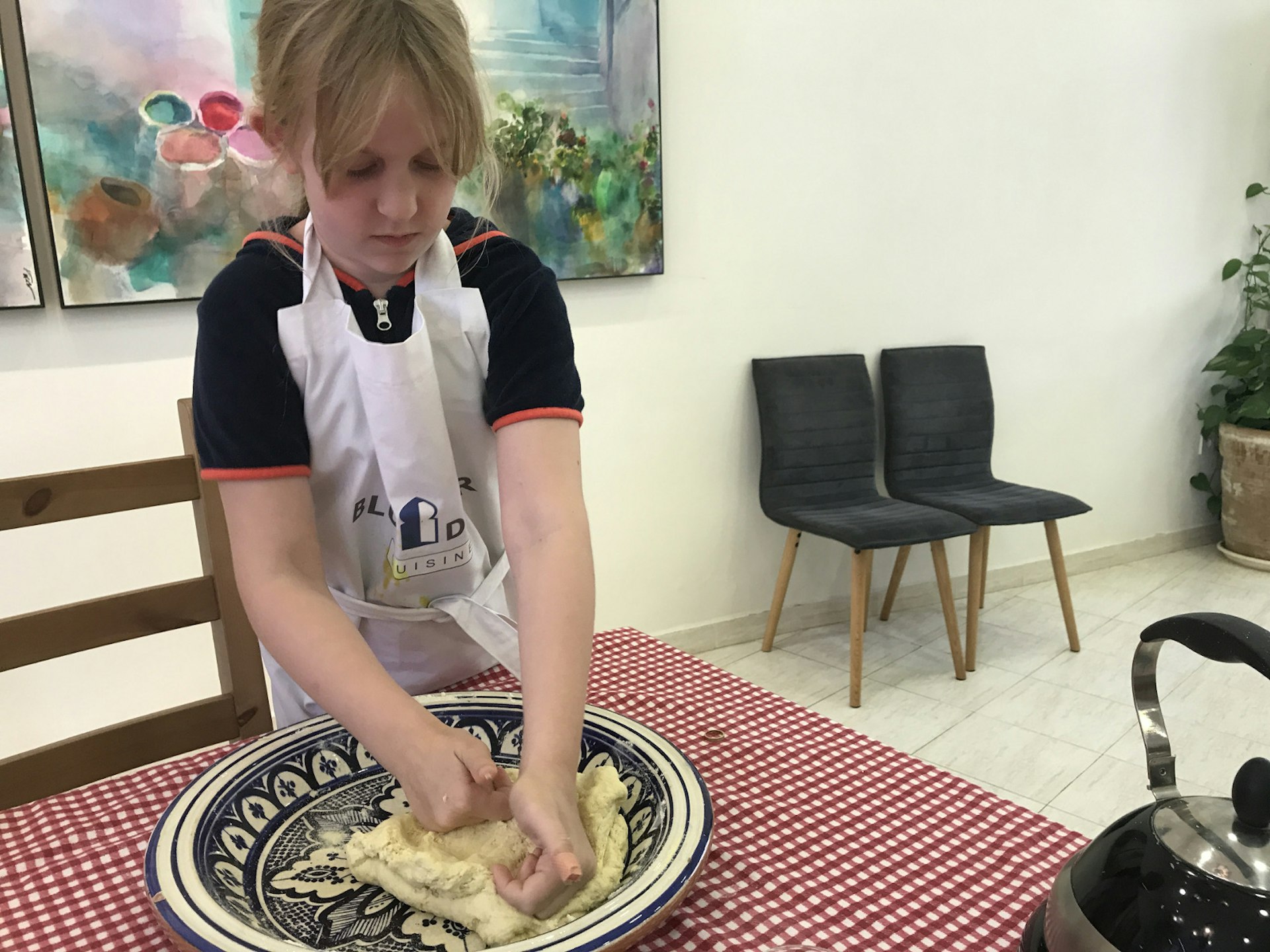 Tabby, looking like a true professional, making her own bread in Morocco 