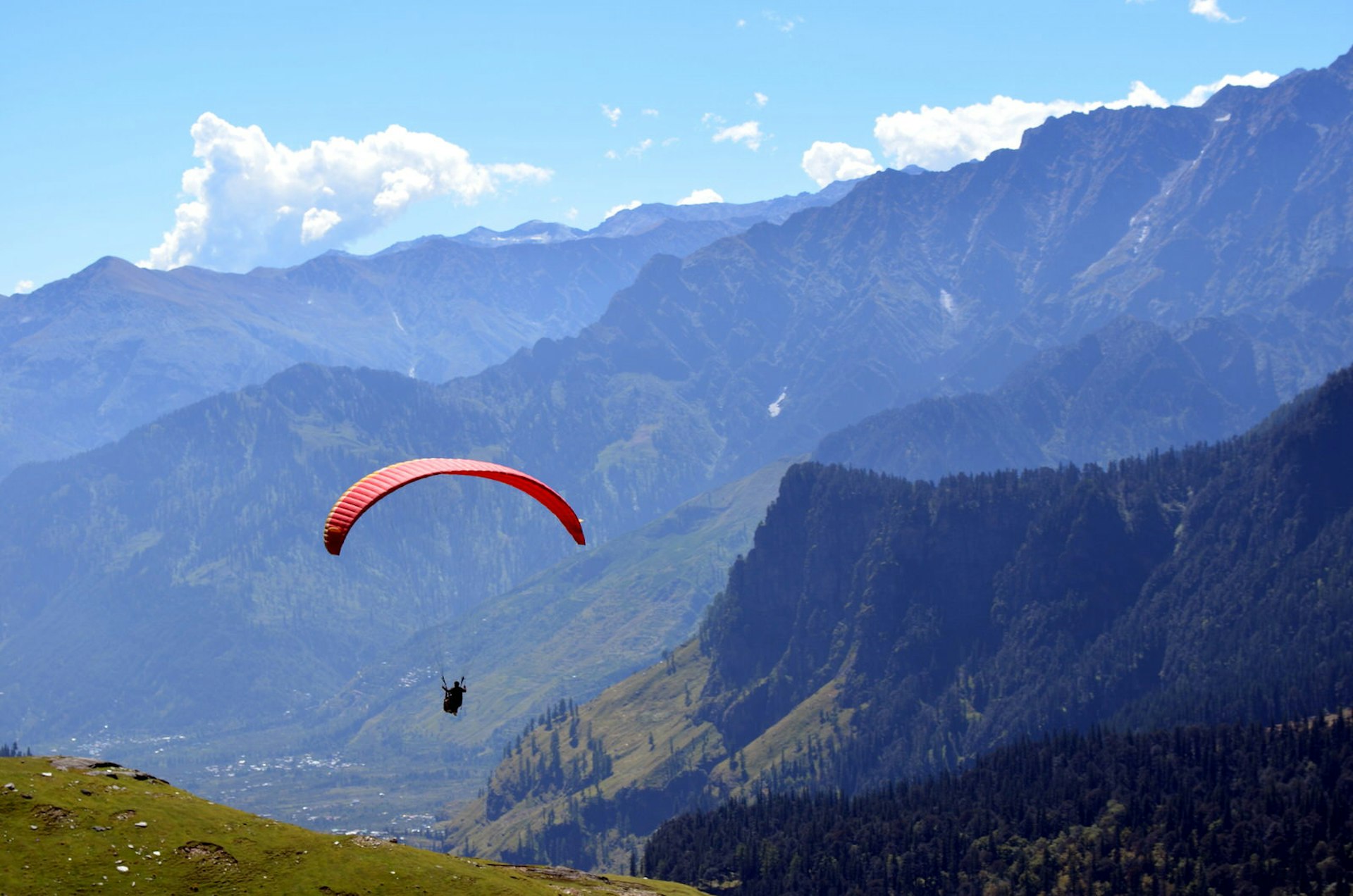 Paraglider against a backdrop of Himalayan hills in Himachal Pradesh