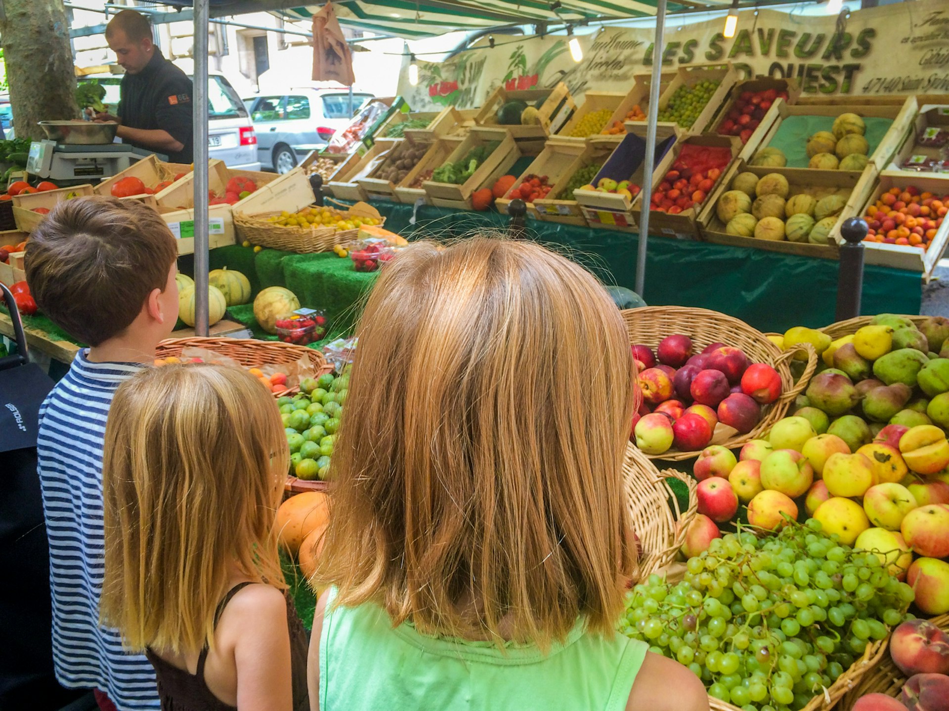 Evelyn and her siblings exploring a colourful food market in Europe