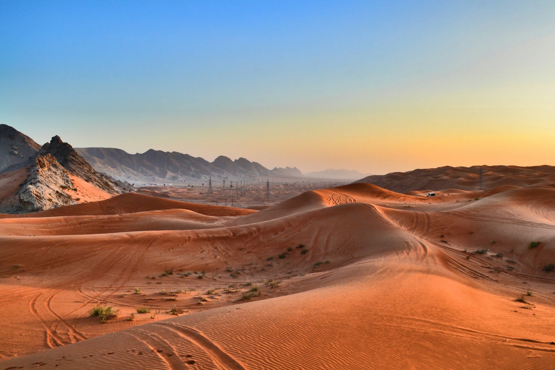 Sand dunes in front of the Hajar Mountains in the deserts of Sharjah, United Arab Emirates