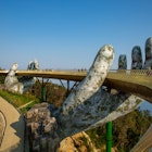 People stroll across the Golden Bridge in Ba Na Hills, which appears to be supported by giant hands