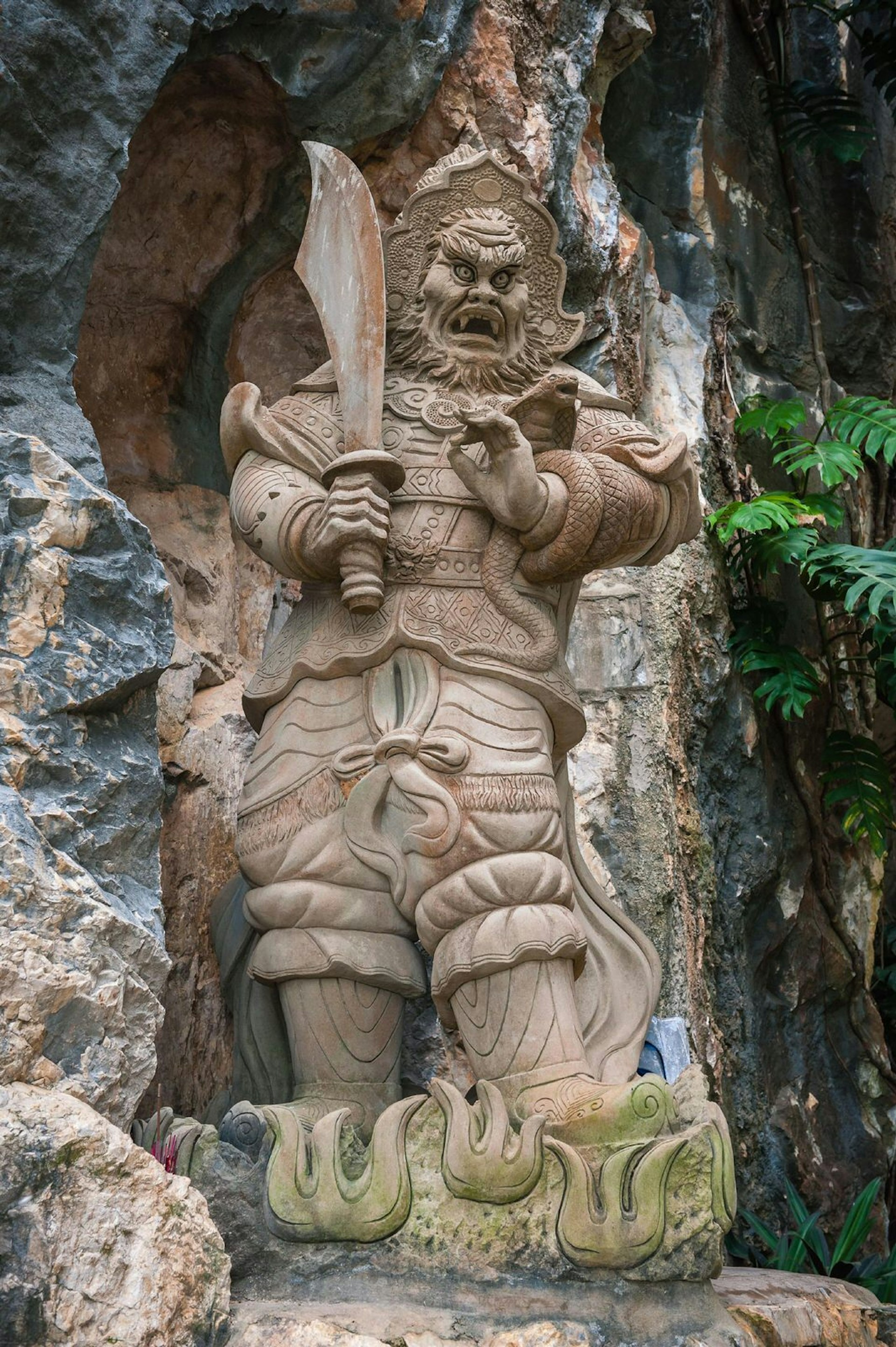 A sculpture of an evil man in Am Phu Cave, the Marble Mountains 