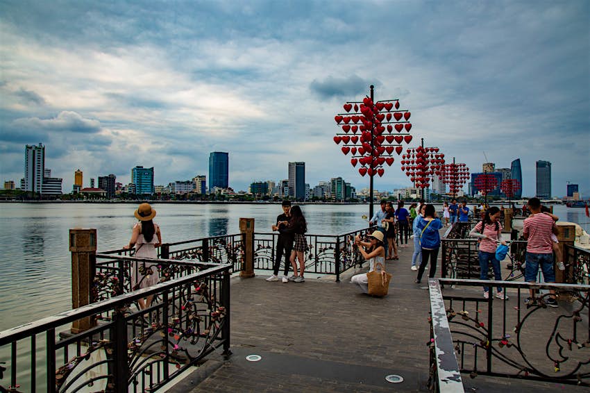 Features - selfie-takers-danang-d6b679a28684 The Han River and tall buildings offer a back-drop for selfie-taking sightseers