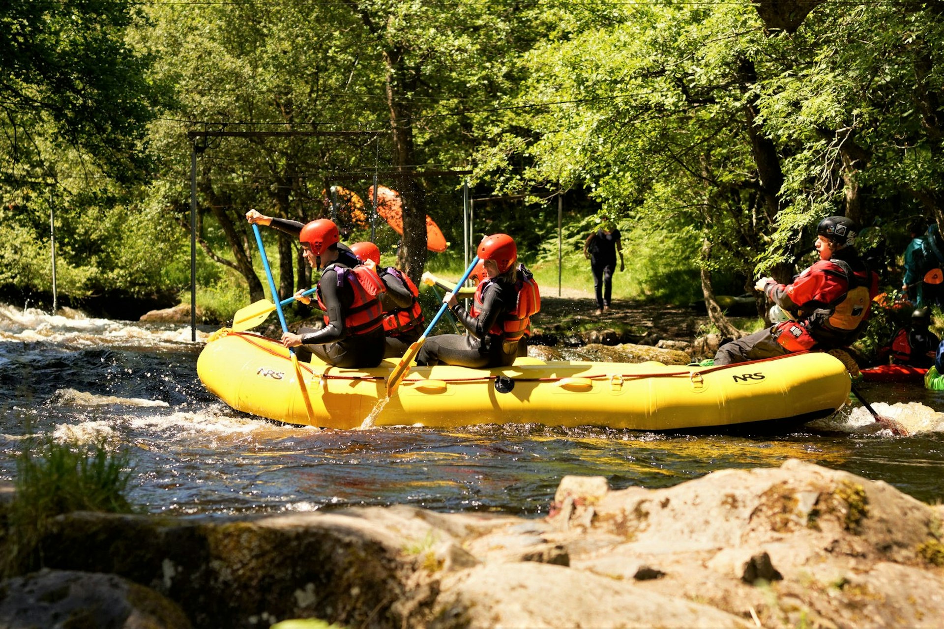 People in a boat going through some rapids