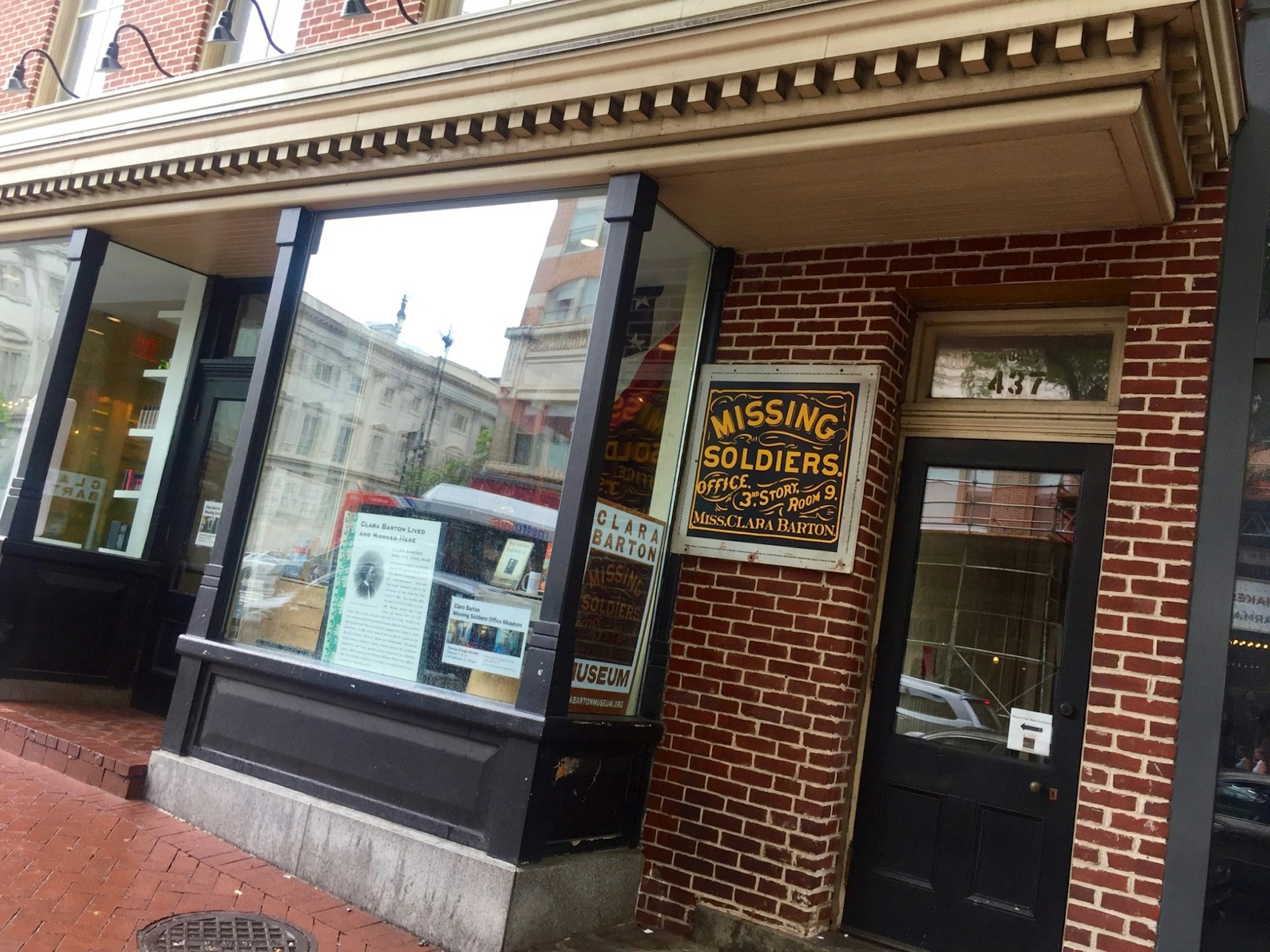 A sign on a brick storefront advertises the Clara Barton Missing Soldiers Office Museum in Washington, DC