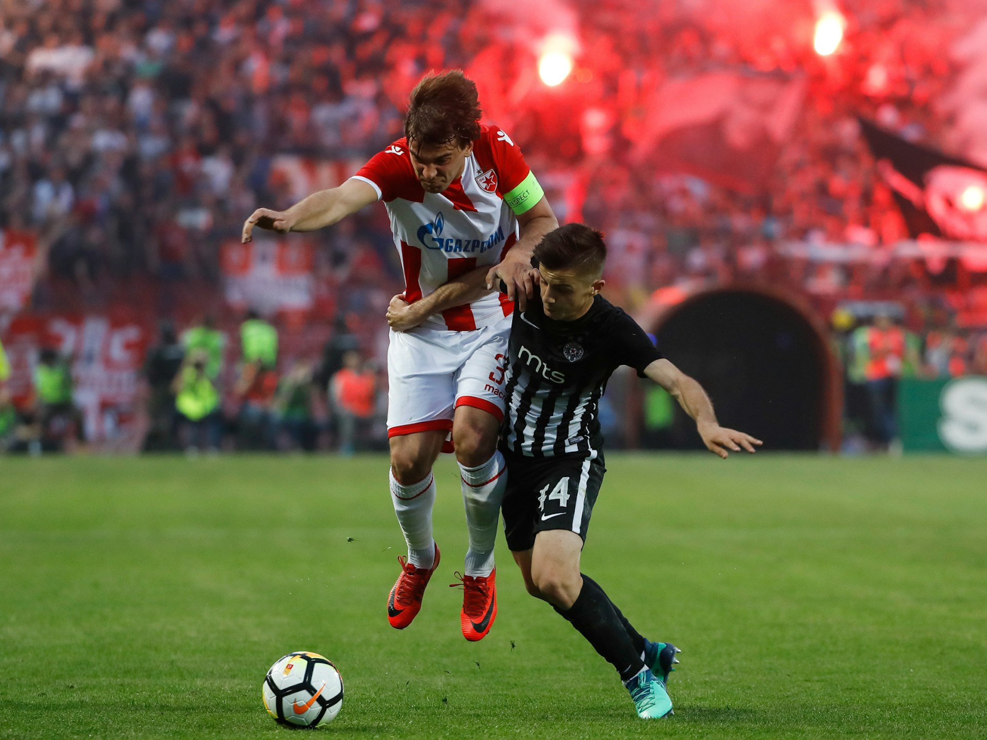 Two football players compete for the ball during a football match at Marakana stadium in Belgrade