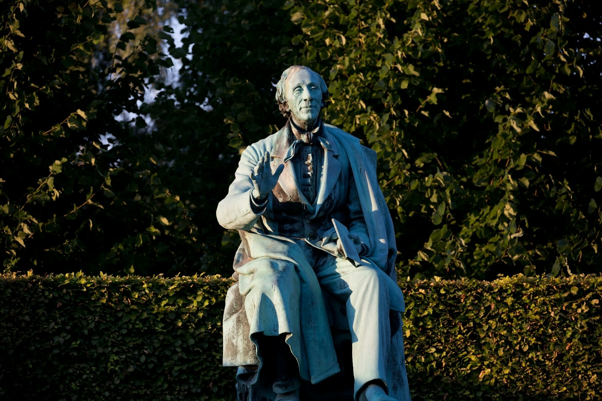 A statue of a sitting Hans Christian Andersen in Kings Garden in the centre of Copenhagen